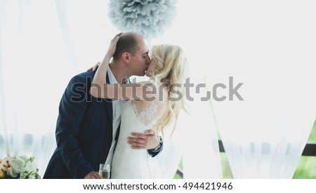 beautiful couple kiss each other on their wedding