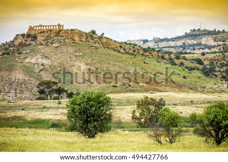 Ancient Greek temple ruins and the city of Agrigento in the background, Sicily. It is the UNESCO World Heritage Site