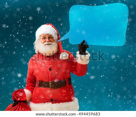 Santa Claus with sack of gifts showing sign speech bubble banner, looking happy excited. Happy Santa Claus on blue background. Merry Christmas. New Year's Eve concept.