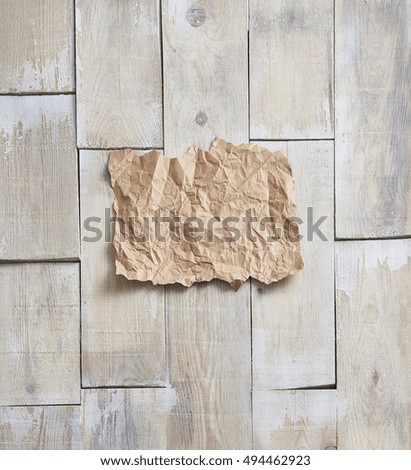 empty, crumpled paper on a wooden floor in the background