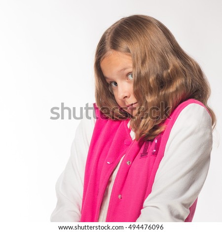 Emotional blonde girl in a pink jacket on a white background