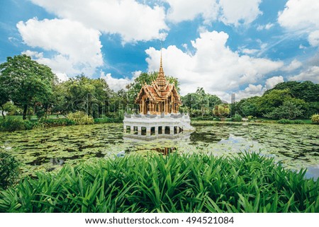 Beautiful landscape of the White Temple in Thailand pond with lotus leaf reflection on blue sky, Thailand.