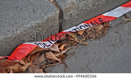 sidewalk and french police tape with leaves