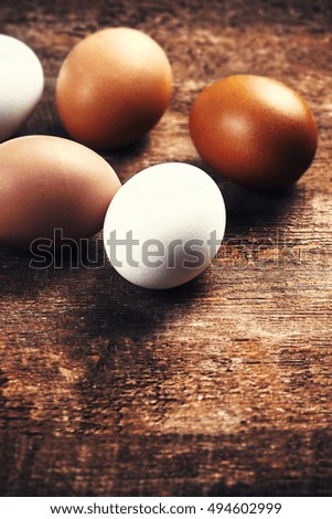 		Farm eggs on a wooden rustic background. Fresh brown and white eggs close up with copy space 
