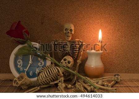 still life with skeleton skull clock and candle light, halloween style
