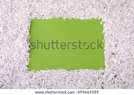 green background with shredded paper frame around