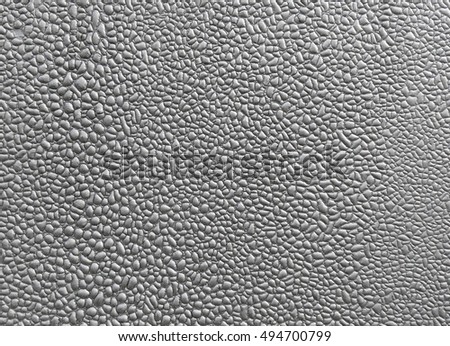 Close-up of silver blistered paint texture. Macro photo of gray bubbles on the wall surface background.