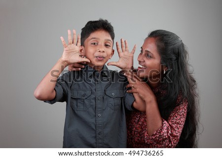 Woman of Indian origin plays with her son 
