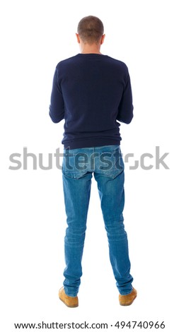 Back view of man in jeans. Standing young guy. Rear view people collection.  backside view of person.  Isolated over white background.  A guy in a black sweater standing
