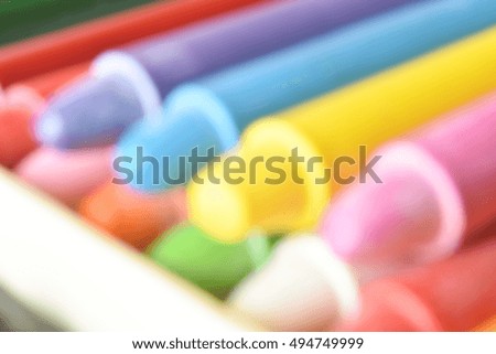 Defocused background of pastels, sticks of dry pigment generally made with wax. Intentionally blurred post production for bokeh effect.