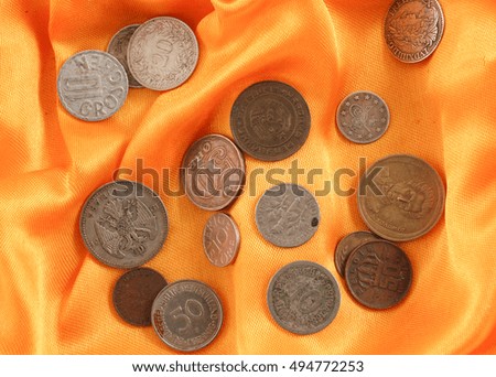  Old coins on yellow fabric