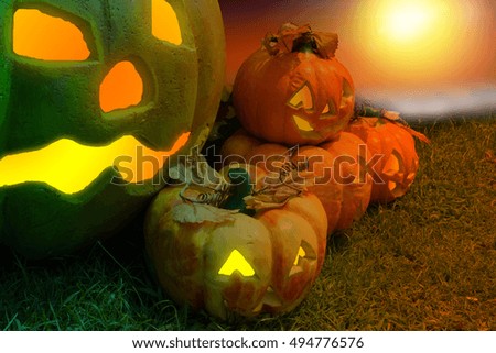 Halloween Pumpkin In A Mystic Forest At Night.Horror background with autumn valley with  spooky pump, pumpkins . Space for your Halloween holiday text.