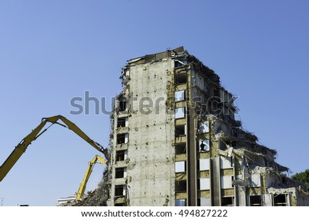 cranes demolishing a mult-storey building