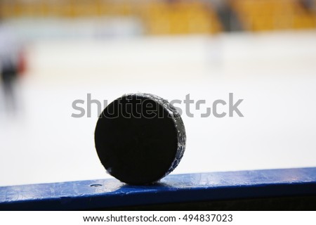 Hockey black puck on ice hockey rink