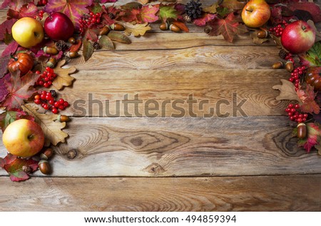 Thanksgiving concept with apples, acorns, berries and fall leaves. Fall background with seasonal berries and fruits. 