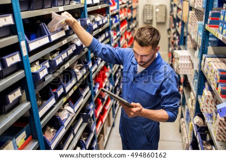 car service, repair, maintenance and people concept - auto mechanic man or smith with tablet pc computer looking for spares at workshop or warehouse Royalty-Free Stock Photo #494860162