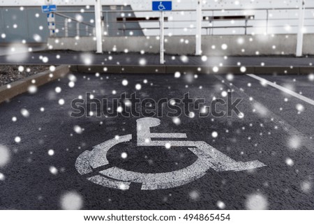 traffic laws and highway code concept - car parking road sign for disabled outdoors over snow