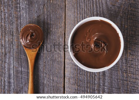 chocolate hazelnut spread on rustic wooden table. top view Royalty-Free Stock Photo #494905642