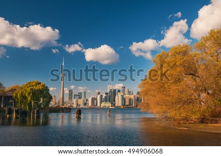 View of Toronto skyline from center island with seasonal autumn trees