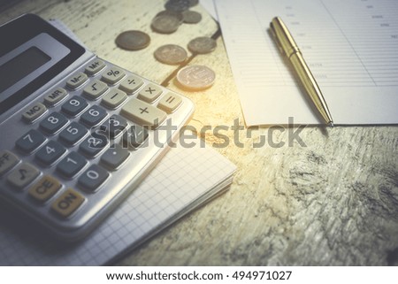 calculator paper pen business concept coins on your desktop