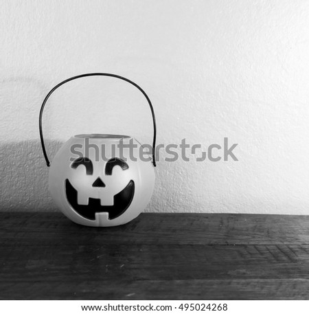 Toy Jack-O-Lantern on wood table.