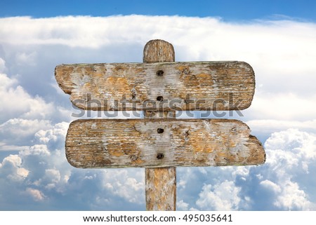 Old Wooden Signpost with Sky. Concept of a guide in different areas of life.