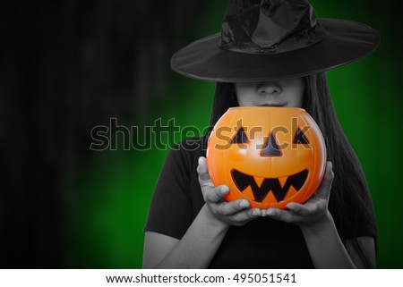 Witch magic holloween woman holding pumpkin toy.