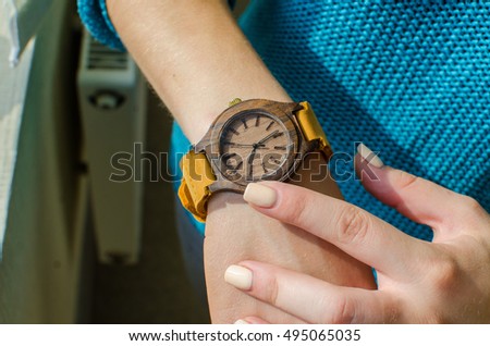 
wooden watch on the hand