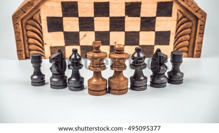 Retro styled or retro color wooden chess case pieces. Slightly de-focused and close-up shot. Copy space.