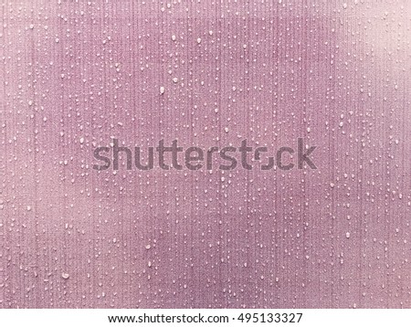 Raindrop on pink wall. Abstract texture background.
