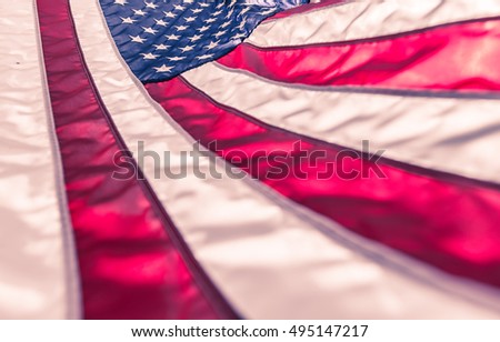 American flag in red white stripe,stars and blue symbolic of patriot,glory,honor of the country nation,freedom in vintage toned color with sky and sun shine background and selective focus