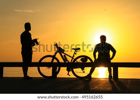 Silhouette of group in the morning at the beach waiting for the sunrise.