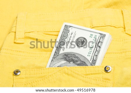 U.S. 100, 20 and 10 dollar bills in his back pocket jeans yellow youth