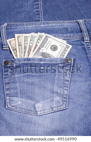 U.S. 100, 20 and 10 dollar bills in his back pocket jeans blue