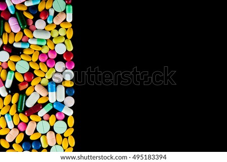 Part of pills pile on black background