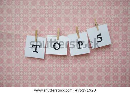 white sheets of paper on a pink background, white sheets on clothespins,word on paper Royalty-Free Stock Photo #495191920