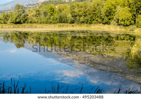 mountains, sky and clouds reflected in the lake