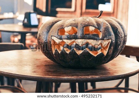 Halloween carved pumpkin on a street cafe table