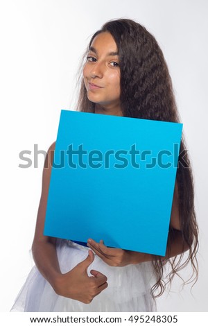 Girl brunette in a white dress with a blue sheet of paper for notes on a white background
