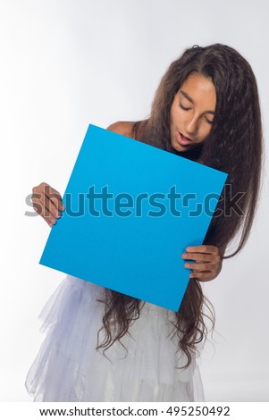 Girl brunette in a white dress with a blue sheet of paper for notes on a white background