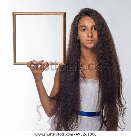 Girl brunette in a white dress with a frame in the form of pictures on a white background