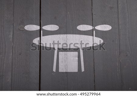 White drone on black wooden background