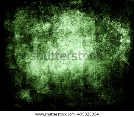 Beautiful green abstract vintage grunge background with faded central area for your text or picture, scratched scary halloween background with frame