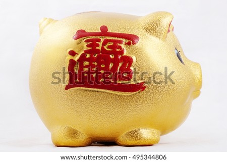 Golden piggy bank	, on which writing "Money"