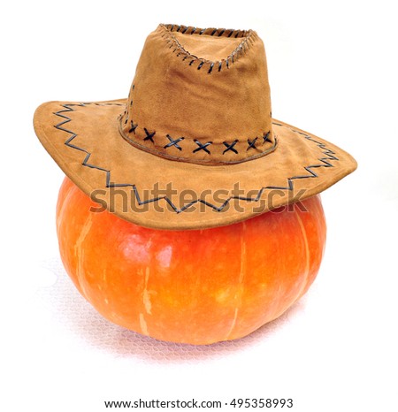 Large pumpkin for Halloween party dressed up in a cowboy hat, isolated on a light background