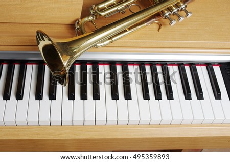 Piano keyboard and trumpet.