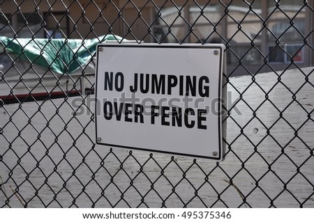 No jumping over fence sign