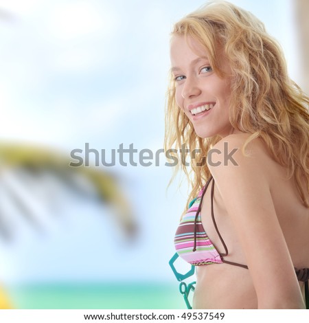 Young beautiful happy blond woman in colorful top of bikini  (summer concept)