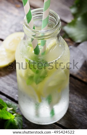 Fresh homemade lemonade in a bottle on the table. Rustic Style. Selective focus