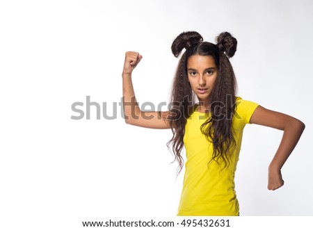 Emotional young brunette girl with long hair in yellow shirt on a white background